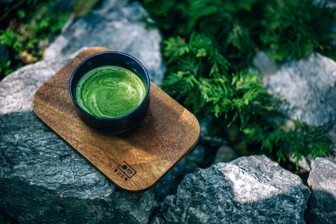 Adult learner sipping matcha tea while studying, symbolising study motivation and focus through online learning adult courses.